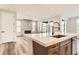 Kitchen island with white quartz countertop and sink at 6664 Bridle Creek Pt, Castle Pines, CO 80108