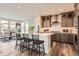 Modern kitchen with gray cabinets, quartz countertops, and an island at 6664 Bridle Creek Pt, Castle Pines, CO 80108