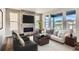 Living room featuring a stone fireplace and large windows at 6664 Bridle Creek Pt, Castle Pines, CO 80108