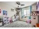 bedroom with toys, a ceiling fan, and a window at 11882 Edenfeld St, Parker, CO 80134