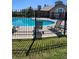 Community pool with lounge chairs and a surrounding fence at 2855 Rock Creek Cir # 158, Superior, CO 80027