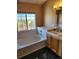 Bathroom with soaking tub and double vanity at 2855 Rock Creek Cir # 158, Superior, CO 80027
