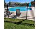 Community pool with lounge chairs and a metal fence at 2855 Rock Creek Cir # 158, Superior, CO 80027
