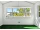 Bright bonus room with large windows offering treetop views and a green carpet at 1843 Spruce St, Boulder, CO 80302