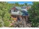 Two-story house with green roof, brick facade, and porch at 1843 Spruce St, Boulder, CO 80302
