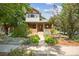 Brick home with a charming front porch and well-maintained landscaping at 1843 Spruce St, Boulder, CO 80302