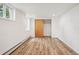Bright finished basement bedroom with wood-look floors and ample closet space at 1843 Spruce St, Boulder, CO 80302