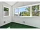 Bright bonus room with large windows offering treetop views and a green carpet at 1843 Spruce St, Boulder, CO 80302