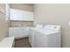 Laundry room with white cabinets, washer, and dryer at 22554 E Peakview Pl, Aurora, CO 80016