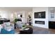 Modern living room with a fireplace and plenty of natural light at 3833 Whispering Sage St, Evergreen, CO 80439