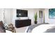 Main bedroom with a large TV, sitting area, and ensuite bathroom access at 3833 Whispering Sage St, Evergreen, CO 80439