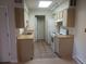 Galley style kitchen with white appliances and wood laminate flooring at 1845 N Kendall St # 316D, Lakewood, CO 80214