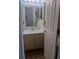 Clean bathroom with single sink vanity, shower/tub combo and tiled floor at 1845 N Kendall St # 316D, Lakewood, CO 80214