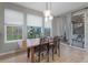 Bright dining area with wooden table, three windows, and backyard view at 23890 E Minnow Dr, Aurora, CO 80016