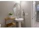 Convenient powder room with pedestal sink and oval mirror at 23890 E Minnow Dr, Aurora, CO 80016