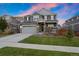 Two-story home with gray siding, attached garage, and landscaped lawn at 23890 E Minnow Dr, Aurora, CO 80016