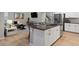 White kitchen island with dark countertop and stainless steel appliances at 23890 E Minnow Dr, Aurora, CO 80016