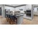 Modern kitchen with white cabinets, stainless steel appliances, and a large island at 23890 E Minnow Dr, Aurora, CO 80016