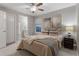 Bright bedroom featuring a comfortable bed, a ceiling fan, and neutral-toned decor at 23890 E Minnow Dr, Aurora, CO 80016