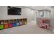 Playroom featuring built-in storage, a large TV, and toys at 23890 E Minnow Dr, Aurora, CO 80016