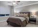Bedroom with a ceiling fan, large window, and neutral color palette at 23890 E Minnow Dr, Aurora, CO 80016