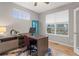 Bright home office features wood-look floors, built-in shelving, and large windows at 23890 E Minnow Dr, Aurora, CO 80016