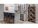 Basement wet bar with granite countertop, wine rack, and beverage refrigerator at 23890 E Minnow Dr, Aurora, CO 80016