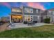 Two story home with covered patio, seating area, and grilling station at 23890 E Minnow Dr, Aurora, CO 80016
