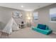 Playroom with a teepee, small table and chairs, and a teal couch at 23890 E Minnow Dr, Aurora, CO 80016