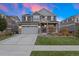 Two-story home with gray siding, attached garage, and landscaped lawn at 23890 E Minnow Dr, Aurora, CO 80016