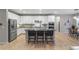 Modern kitchen with white cabinets, stainless steel appliances, and a large island at 23890 E Minnow Dr, Aurora, CO 80016
