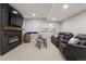Finished basement featuring a fireplace, two leather recliners and a wet bar at 23890 E Minnow Dr, Aurora, CO 80016