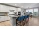 Modern kitchen with white cabinets, stainless steel appliances, and a large island at 23890 E Minnow Dr, Aurora, CO 80016