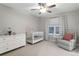 Charming Bedroom with crib, armchair, and built-in shelving at 23890 E Minnow Dr, Aurora, CO 80016