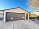 Detachable garage with dark brown doors and concrete pad at 6187 Depew St, Arvada, CO 80003