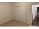 Bedroom with double door closet and access to hallway at 4630 Copeland Cir # 102, Highlands Ranch, CO 80126