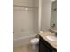 Clean bathroom with shower/tub combo, neutral tile, and dark vanity at 4630 Copeland Cir # 102, Highlands Ranch, CO 80126