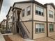 Tan two-story building with dark brown accents and stairs leading to the entrance at 4630 Copeland Cir # 102, Highlands Ranch, CO 80126