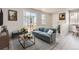 Bright living room with gray sofa and sliding glass door at 14061 Deertrack Ln, Parker, CO 80134