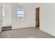 Bright bedroom with grey carpeting and ensuite bathroom access at 1145 Raindance Pl, Erie, CO 80516