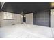 Attached garage with dark gray door and ample parking space at 6035 Everett St, Arvada, CO 80004