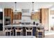Modern kitchen with wood cabinets, quartz countertops, and island seating at 3362 W 32Nd Ave, Denver, CO 80211