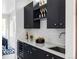 Elegant wet bar featuring dark cabinetry and quartz countertops at 3362 W 32Nd Ave, Denver, CO 80211