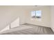 Bright bedroom with neutral carpeting and large window offering natural light at 1296 S Algonquian St, Aurora, CO 80018