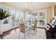 Sunlit dining room features a glass-top table and access to the backyard at 4851 Preserve Pkwy, Greenwood Village, CO 80121