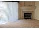 Living room with corner fireplace and neutral carpeting at 3220 Boulder Cir # 103, Broomfield, CO 80023