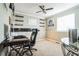 Bright home office features built-in shelving, desk, and comfortable chair at 18522 E Linvale Pl, Aurora, CO 80013