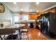 Modern kitchen with wooden cabinets and black appliances at 18522 E Linvale Pl, Aurora, CO 80013