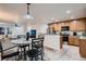 Open concept kitchen with island and dining area at 19045 E 57Th Pl, Denver, CO 80249