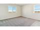 Bright bedroom with grey carpet and two large windows at 4687 Twelve Oaks Way, Castle Rock, CO 80104